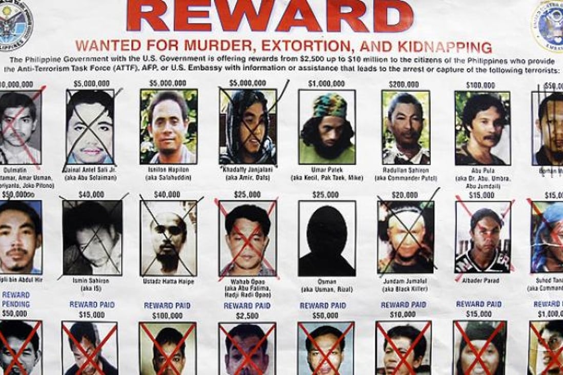 A wanted poster released jointly by the Philippine military and the US embassy in Manila shows terrorist leaders wanted by authorities for murders. Photo: AP