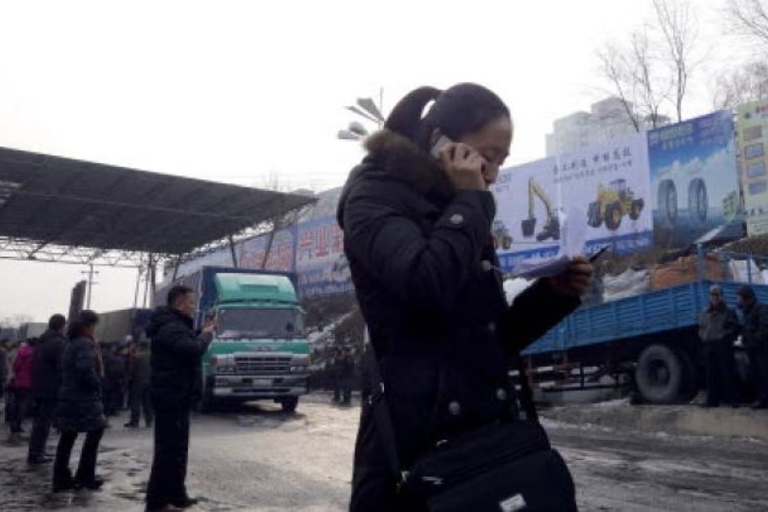 A woman checks the cargo list at a customs port in the Chinese border city of Dandong, Liaoning province, on December 14. Photo: AFP
