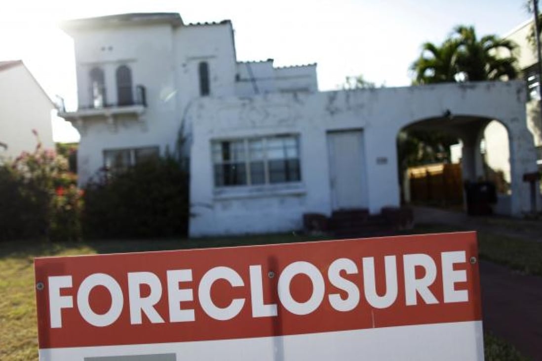 A foreclosure sale sign sits in front of a house in Miami Beach, Florida in this file photo taken February 27, 2009. Photo: Reuters