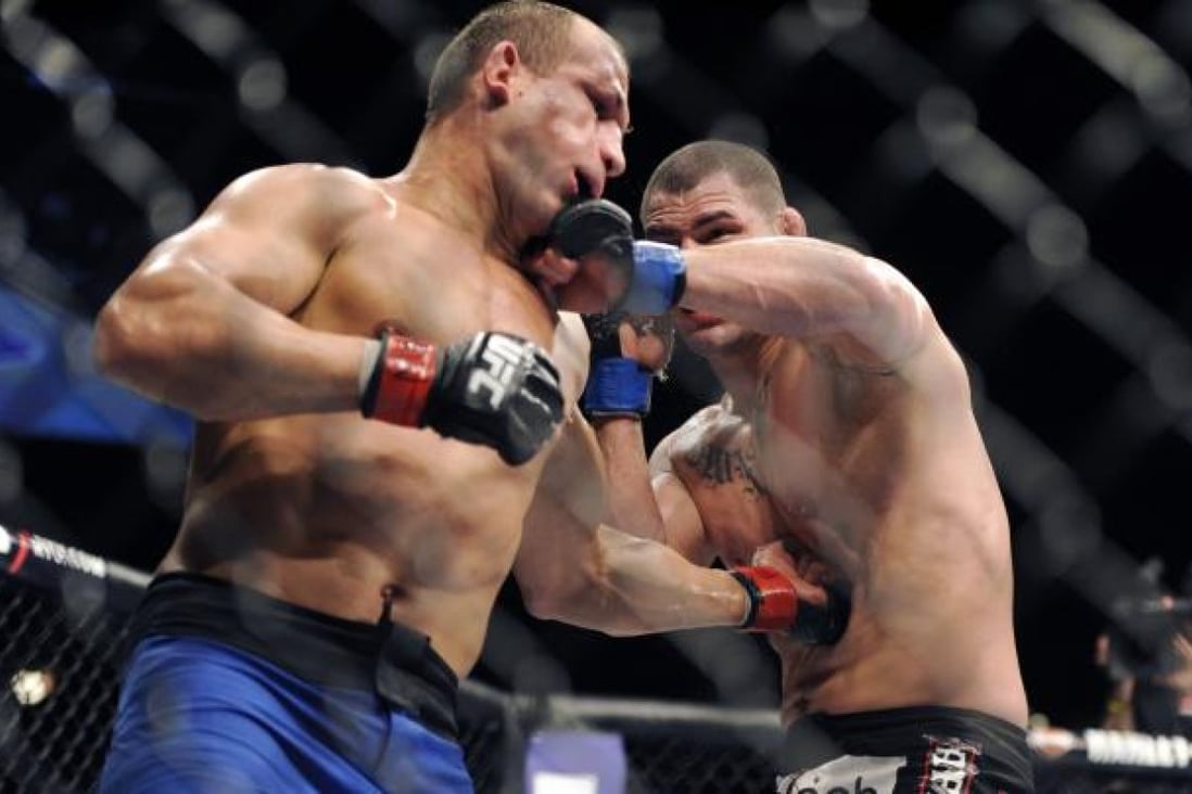 Junior dos Santos of Brazil (left) and Cain Velasquez trade blows during their bout for the UFC heavyweight championship at UFC 155. Photo: AP