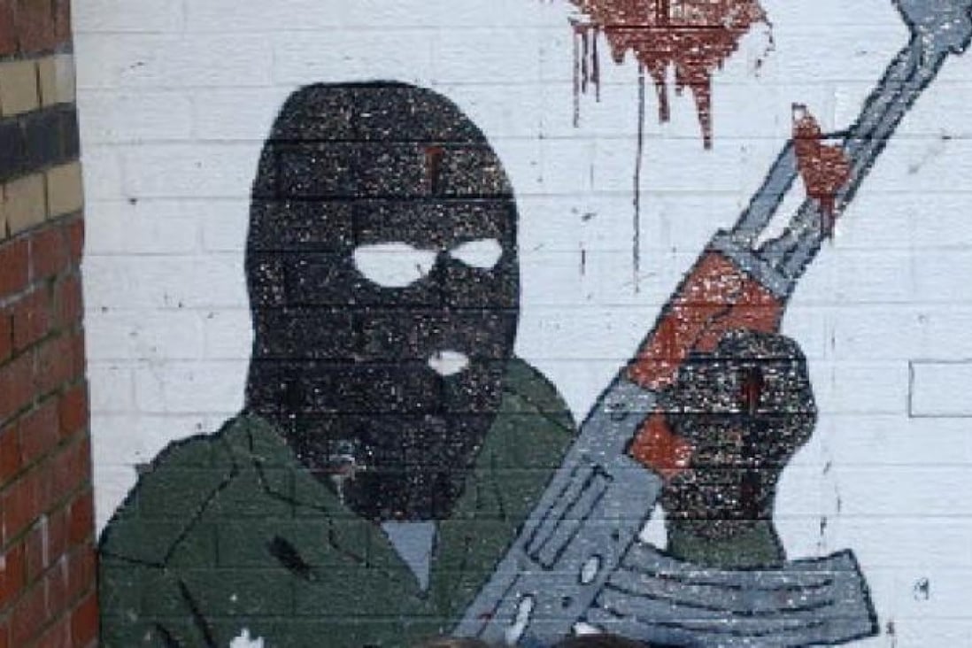 An IRA mural in Belfast recalls Northern Ireland's troubled sectarian past. Two men were in custody on Tuesday after the attempted murder of a police officer in the province. A group calling itself the "New IRA" has claimed responsibility. Photo: AP
