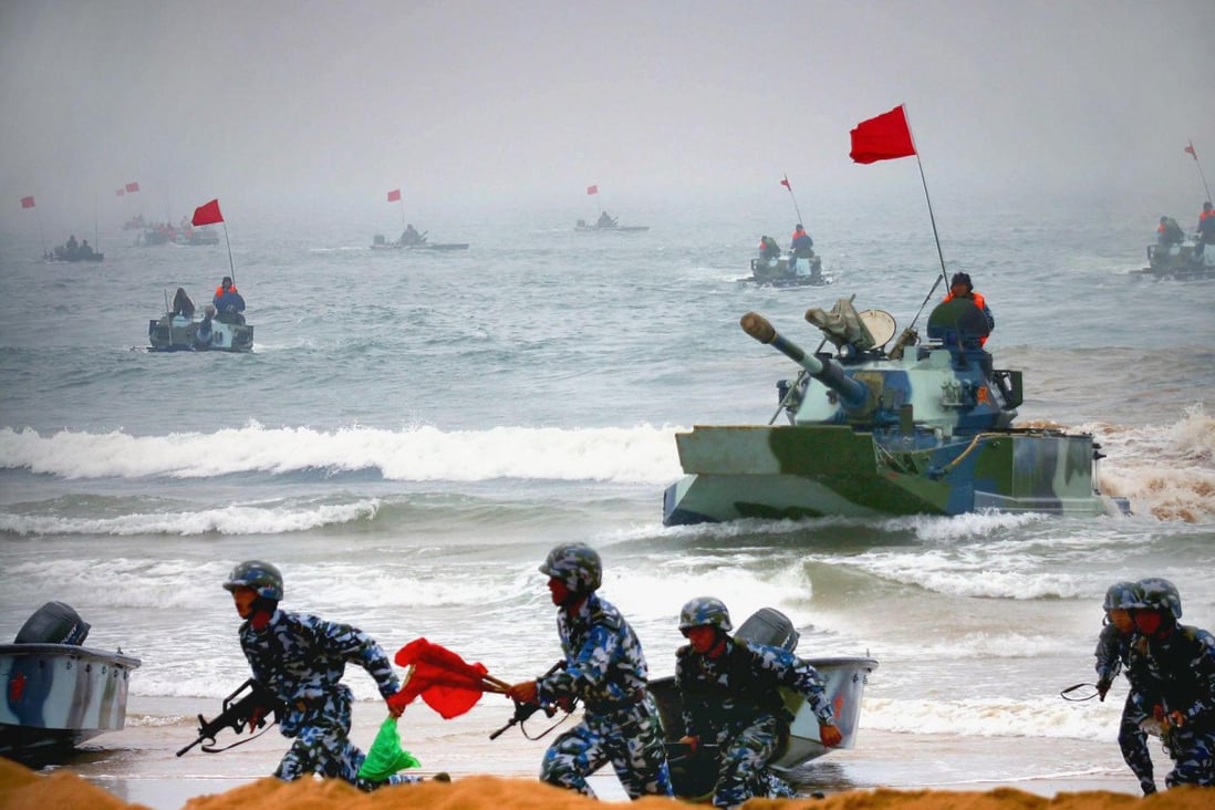 Sino-Russian amphibious tanks and marines storm a beachhead in a 2005 assault drill. Photo: AFP