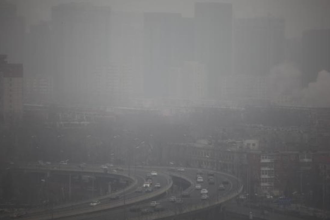 Cars run on an elevated road as buildings in the background are covered in haze, Beijing. Photo: EPA