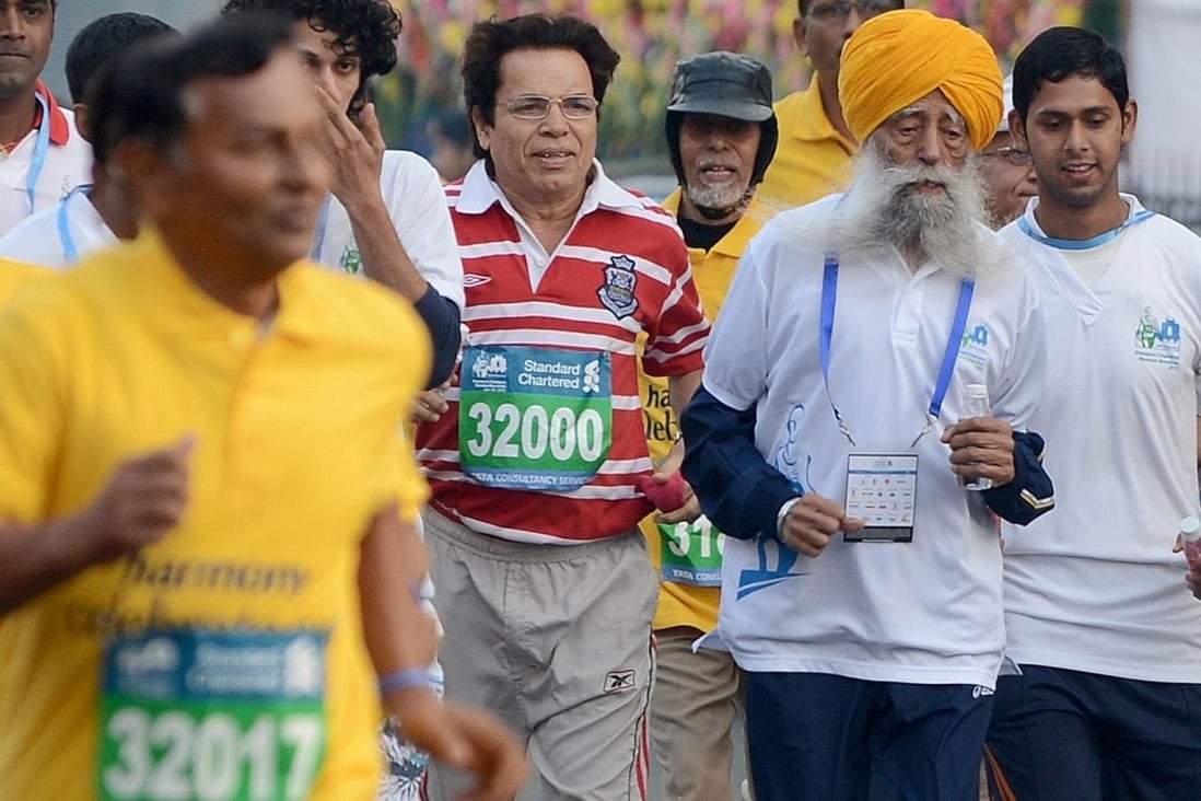 Sikh marathon runner Fauja Singh, 101, shows he is still going strong in the Mumbai Marathon on Sunday. Photo: AFP