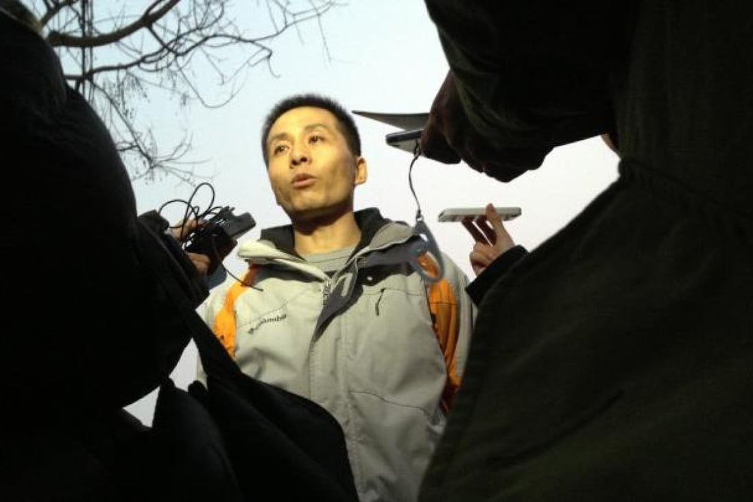 Whistle-blower Zhu Ruifeng speaks to reporters after being questioned by police for a whole day in Beijing on January 28. Photo: SCMP/Simon Song