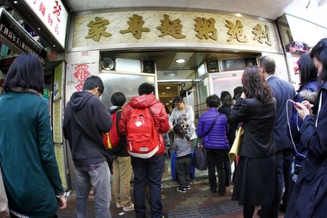 People queue outside Lei Yuen, a 40-year-old noodle and congee shop in Causeway Bay which has closed because of soaring rent. Photo: May Tse