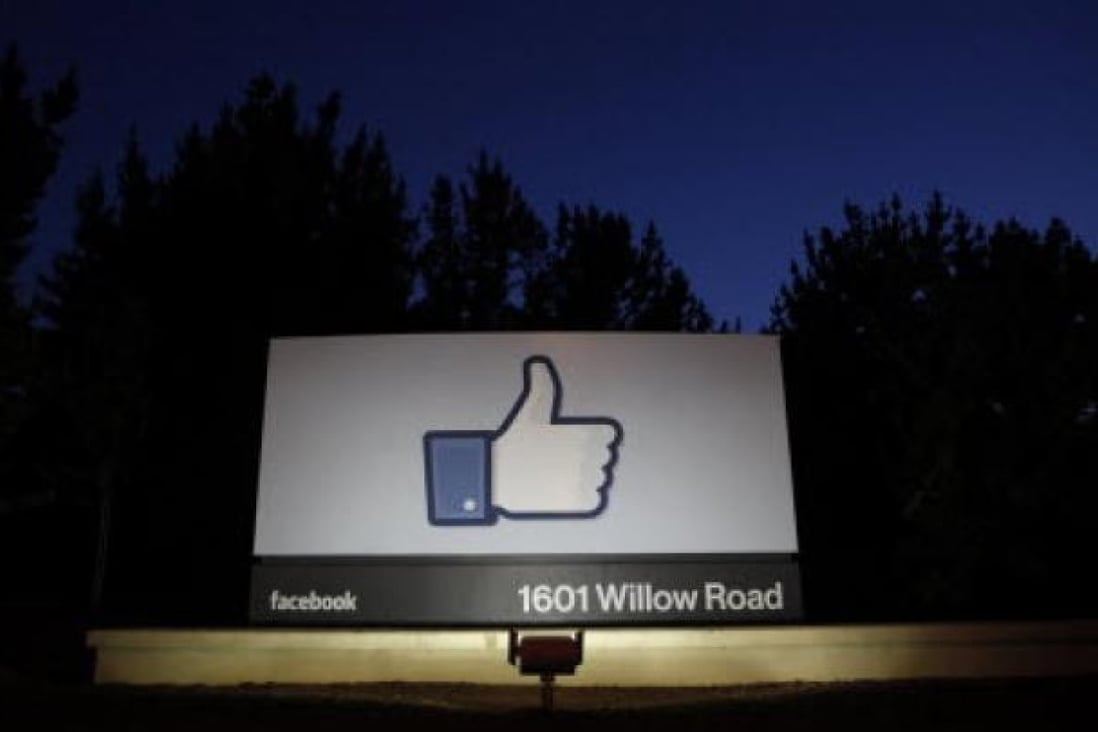The sun rises behind the entrance sign to Facebook headquarters in California. Photo: Reuters