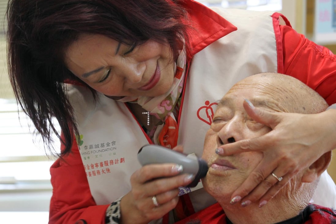 Because they're worth it: Beauty parlour owner Jenny Law, 62, gives Lam Choi-shing, 78, a close shave at Grantham Hospital. Photo: Dickson Lee