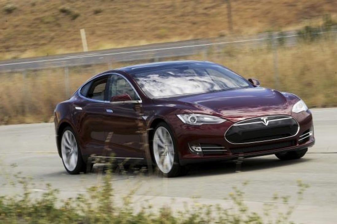 A Tesla Model S electric sedan is driven near the company's factory in Fremont, California. Photo: Reuters