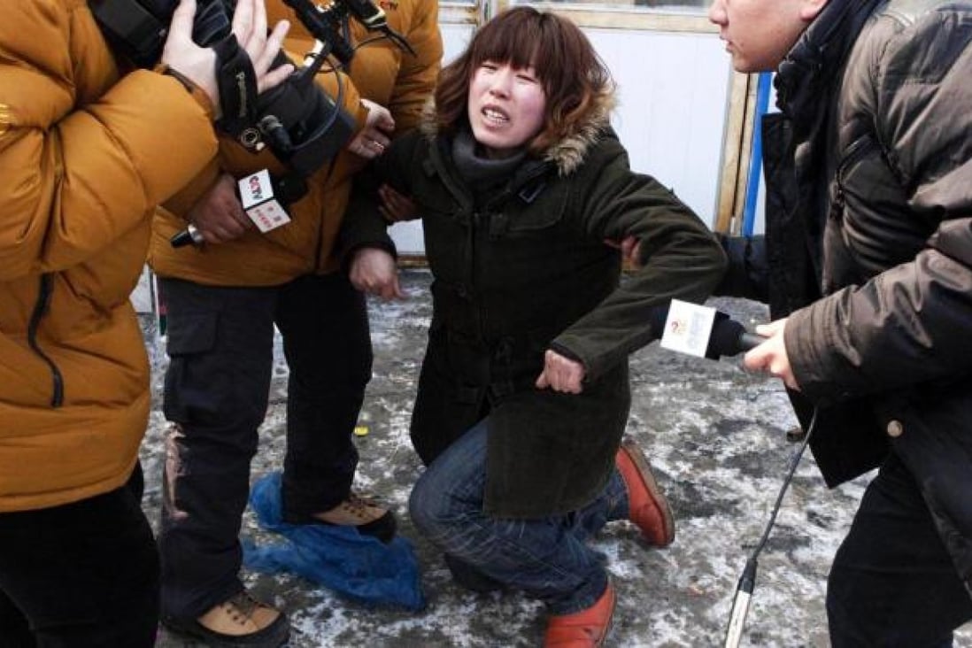 An aunt of the abducted infant Xu Haobo reacts after learning of his abduction. Photo: China Foto Press