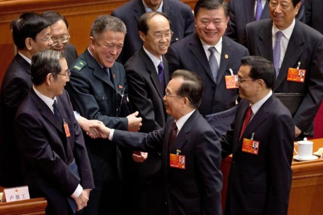 Wen Jiabao shakes hands with delegates after handing over the premiership to Li Keqiang at the NPC. Photo: AP