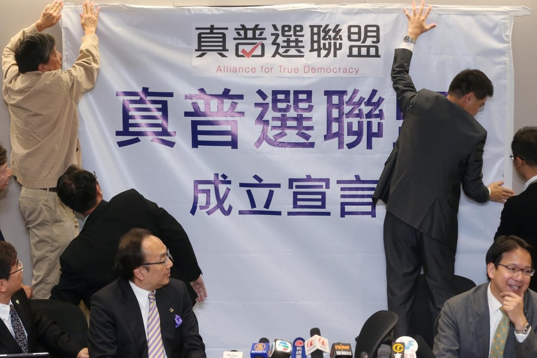 The Alliance for True Democracy pins up a poster. Photo: KY Cheng