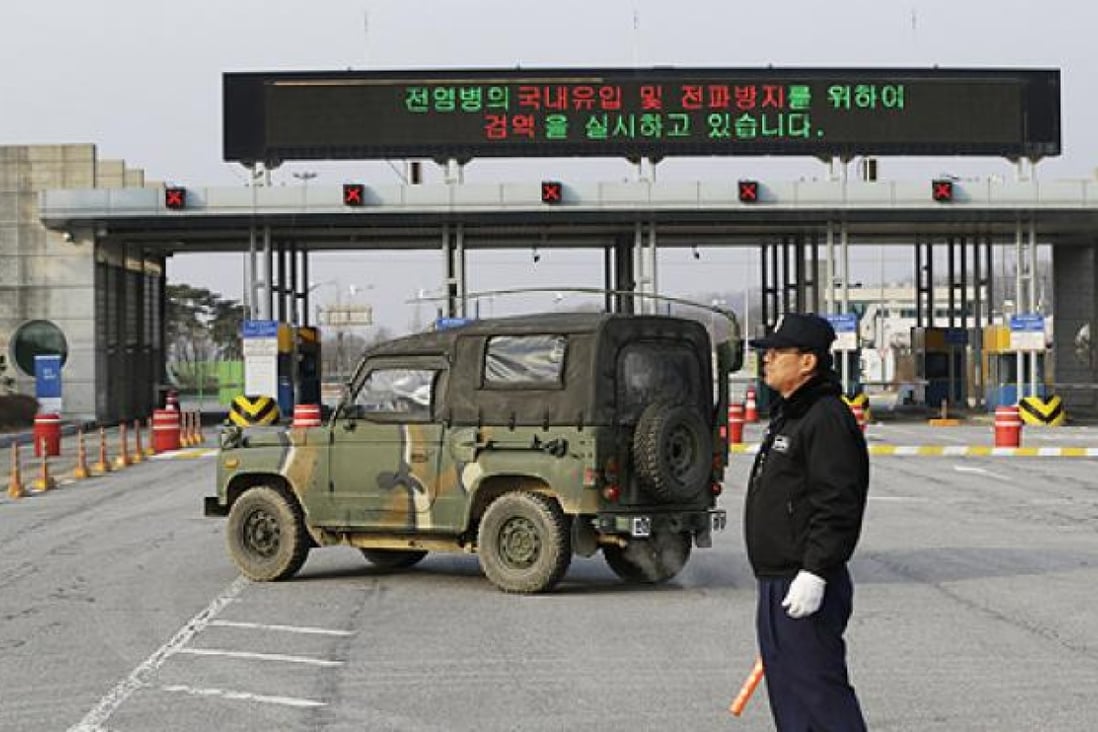 A South Korean military vehicle passes by gates leading to the North Korean city of Kaesong. Photo: AP