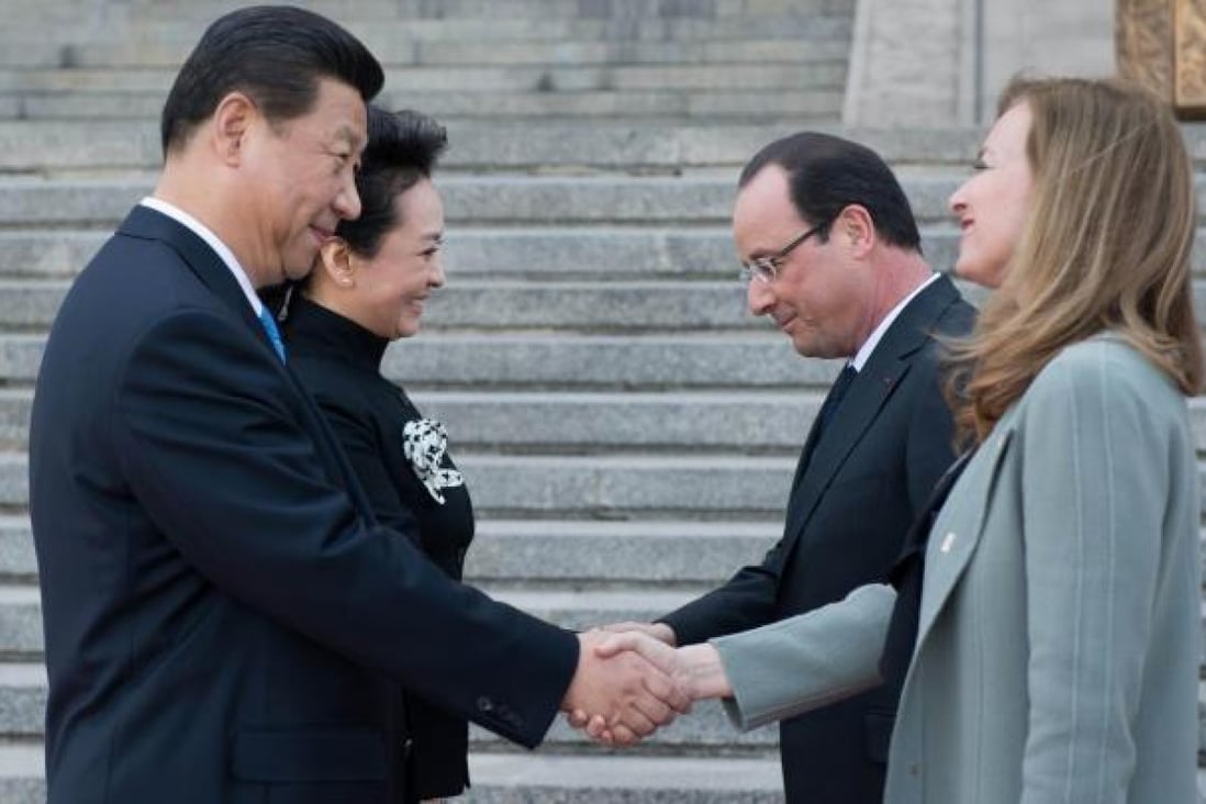 Xi Jinping and his wife, Peng Liyuan, meet Francois Hollande and his partner, Valerie Trierweiler, in Beijing yesterday. Photo: AFP