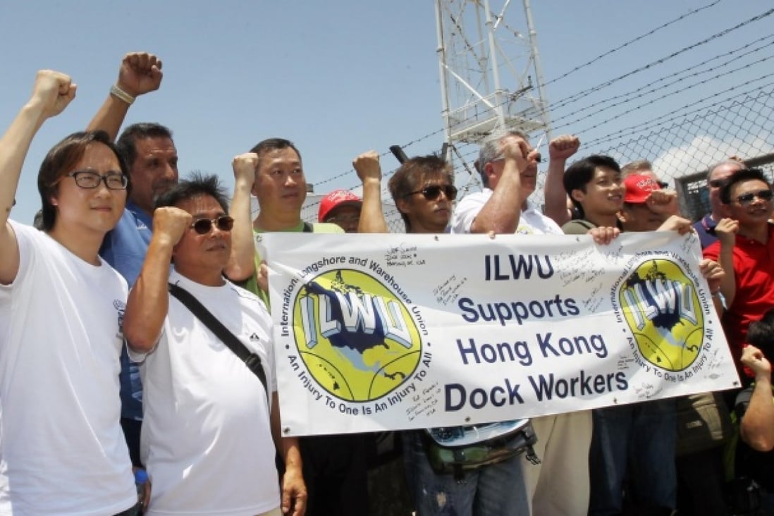 Unionists including Stanley Ho (left) cheer dockers on their first day back at the port. Photo: Edward Wong