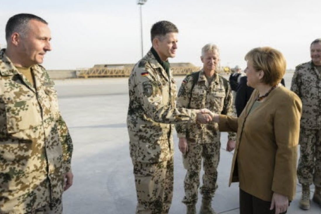 Germany's Chancellor Angela Merkel shakes the hand of a military personnel at Camp Marmal in the northern city of Mazar-i-Sharif in Afghanistan. Photo: Reuters