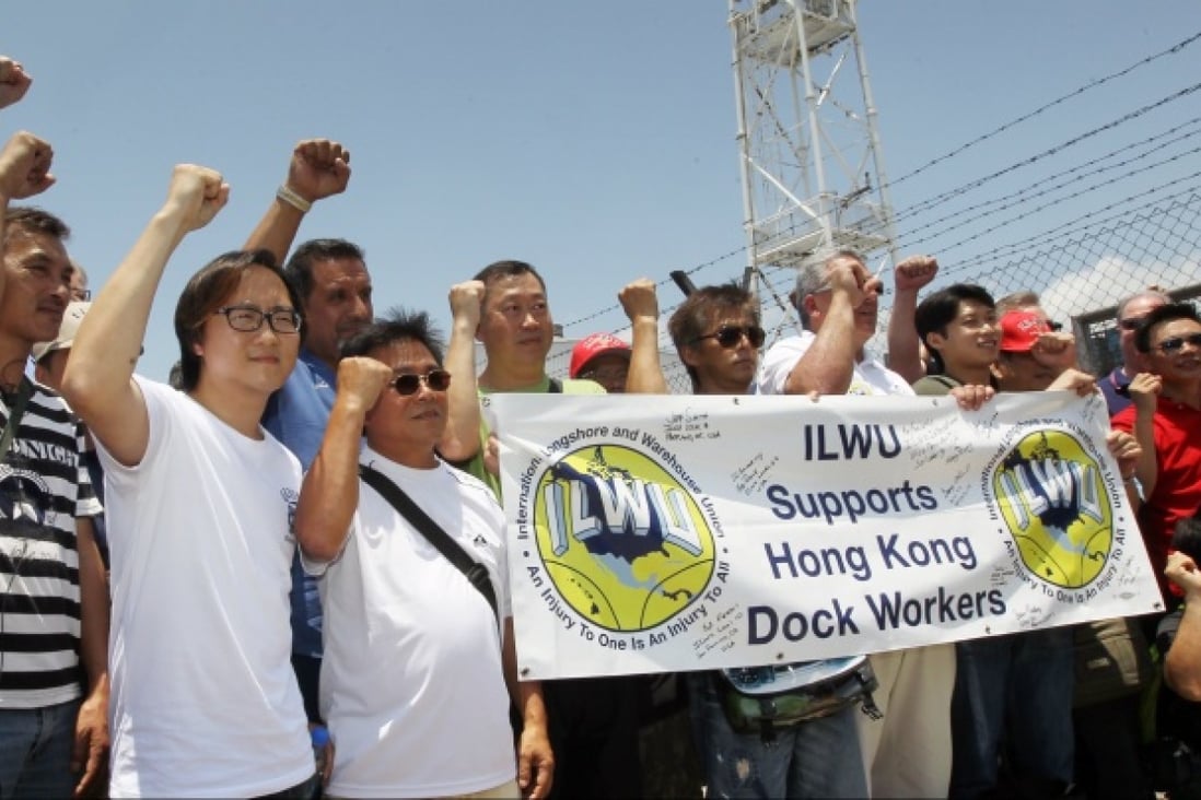 Unionists cheer dockers on their first day back at the port. Photo: Edward Wong