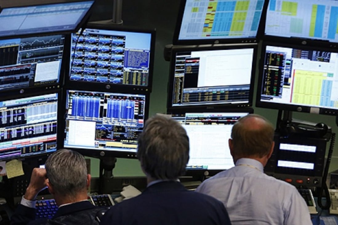 Traders work at Bloomberg terminals on the floor of the New York Stock Exchange. Photo: Reuters