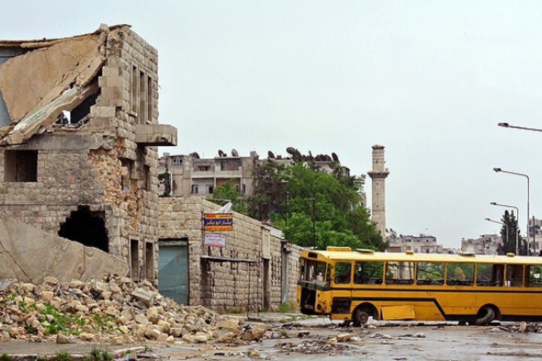 A public bus is used as a barricade along the front line in the Sheikh Maqsud neighbourhood in the northern Syrian city of Aleppo. Photo: AFP