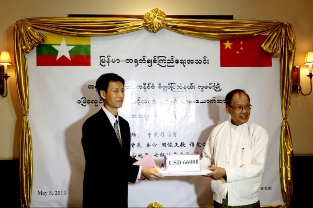 Chinese Embassy Counselor Lu Zhi (left) accepts the donation handed over by Chairman of Myanmar-China Friendship Association U Sein Win Aung in Yangon, Myanmar. Photo: Xinhua