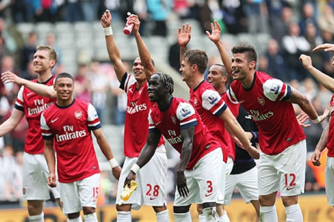 Arsenal players celebrate their victory after the final whistle in the English Premier League football match against Newcastle United, on Sunday. Photo: AFP