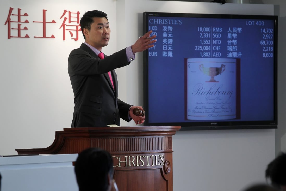 Simon Tam, head of wine for China at Christie's, conducts the auction of Henry Tang's 810-lot collection. Photo: K.Y. Cheng