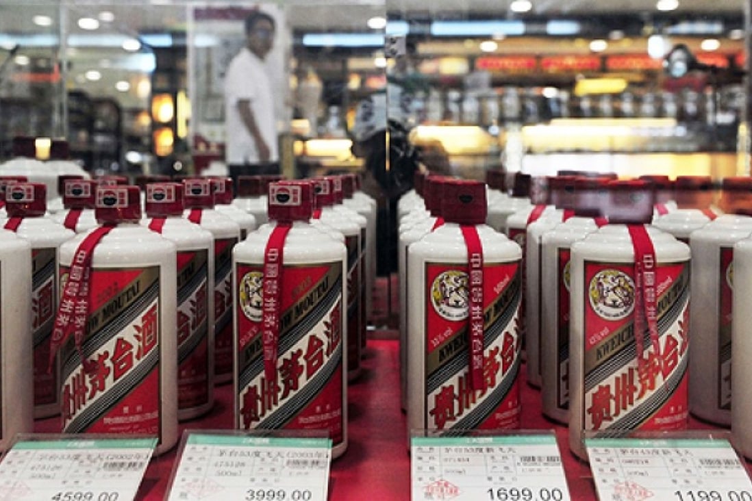 A customer walks past a glass case displaying Maotai liquor, a form of baijiu, at a supermarket in Shenyang, Liaoning province. Photo: Reuters