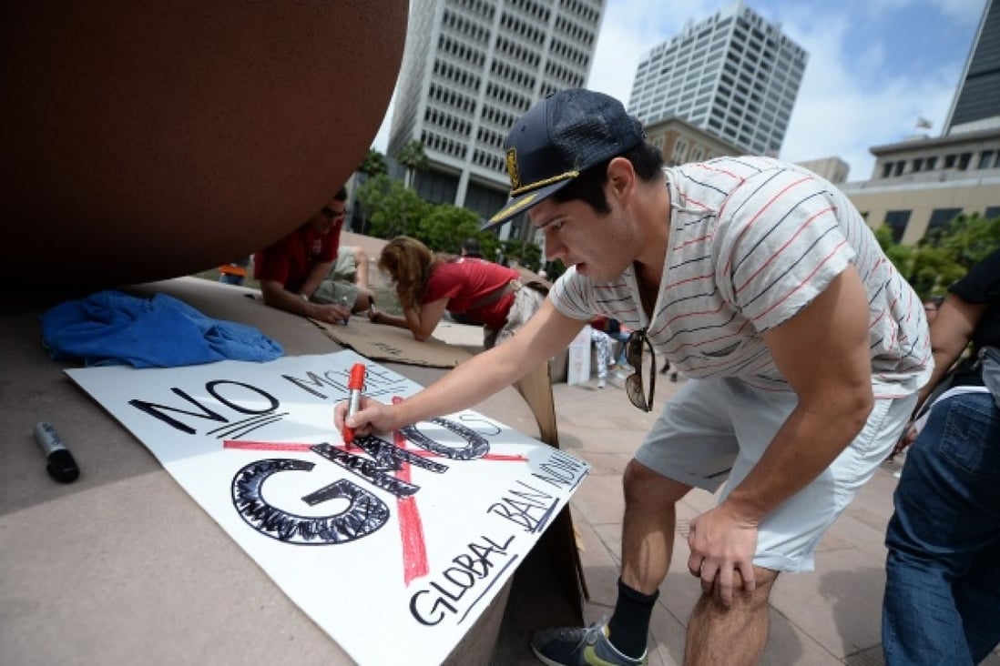A protestor makes a sign for a May 25 protest against chemical giant Monsanto in Los Angeles. The discovery of an unapproved strain of genetically modified wheat has revived concerns about  GM products. Photo: AFP