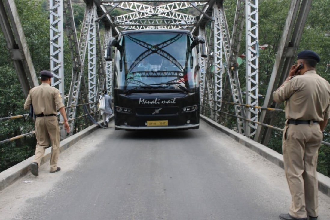 Indian police stop a tourist bus at a checkpoint put in place following the rape of a US tourist in the Indian hillstation town of Manali. Photo: AFP