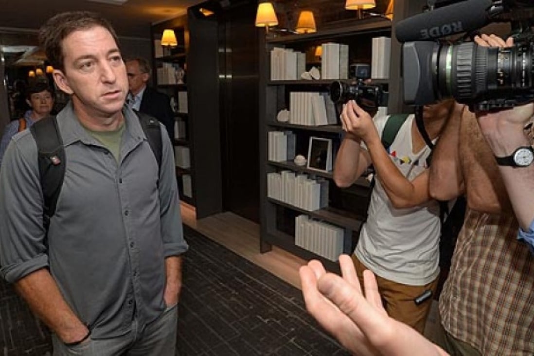 Guardian reporter Glenn Greenwald who interviewed NSA whistleblower Edward Snowden talks to reporters at the W Hotel in Kowloon on Monday. Photo: Felix Wong