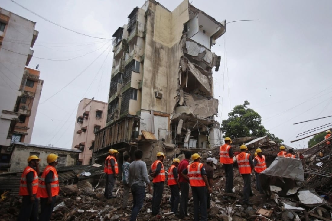 Rescue workers search through rubble at the site of a collapsed residential building in Mumbai. Photo: Reuters