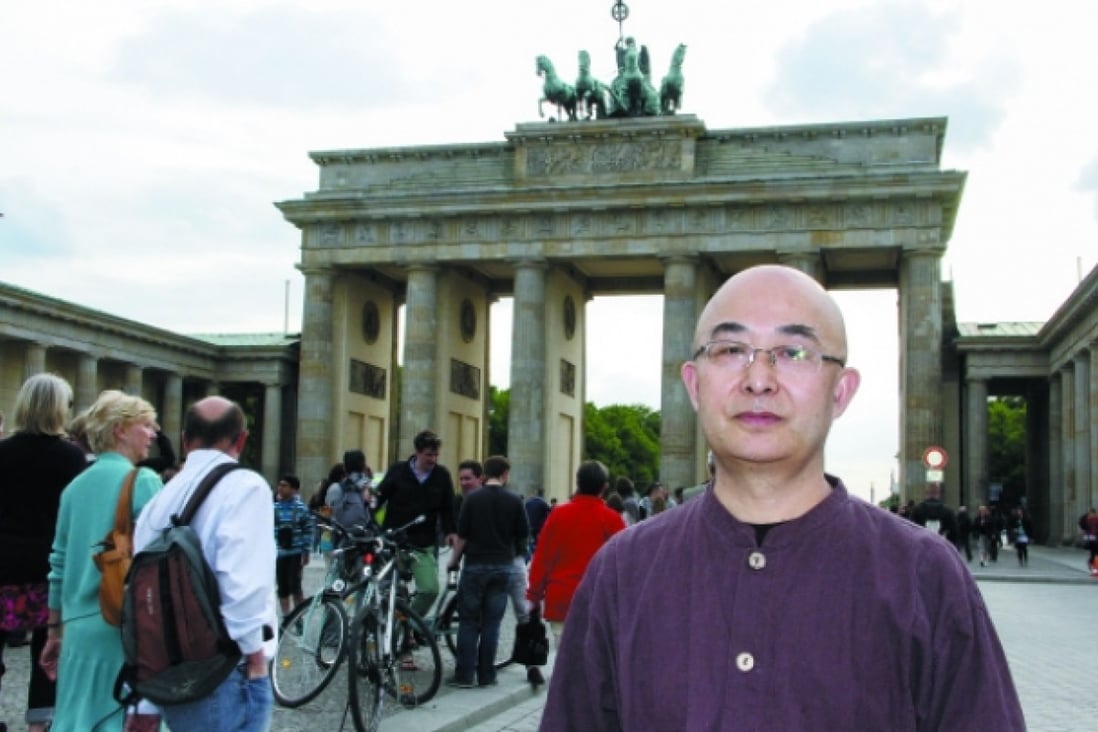 Liao Yiwu in front of the Brandenburg Gate, Berlin, Germany. Photo: Shirley Lau