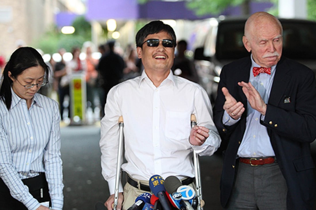 Chen Guangcheng, with NYU professor Jemore Cohen (right), arrives at NYU in May 2012. Photo: AFP