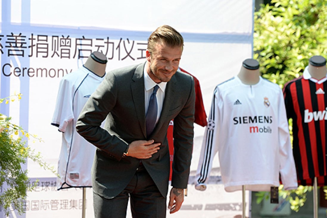 David Beckham is on his second Beijing visit in three months. His jerseys were part of a fund-raising auction for youth soccer in China. Photo: Xinhua