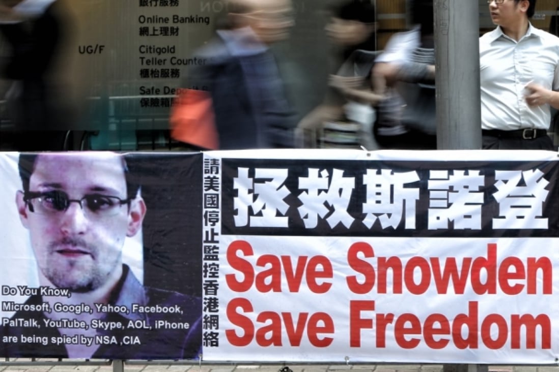 A banner supporting Edward Snowden, a former contractor at the National Security Agency, is seen at Central district. Photo: David Wong