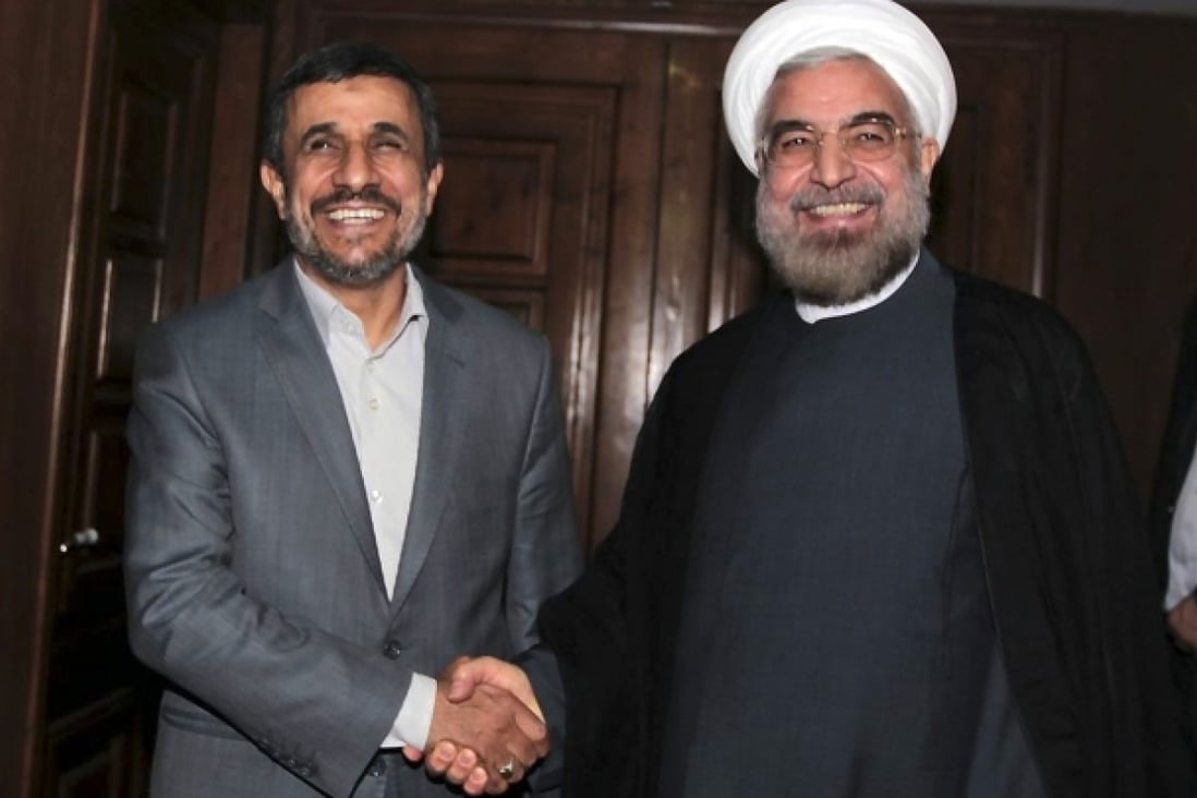 Outgoing Iranian President Mahmoud Ahmadinejad (left) shakes hands with President elect Hasan Rowhani. Photo: AP