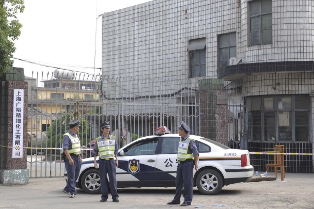 Security officers stand guard at the murder site of Shanghai Guangyu fine chemical company in Baoshan district, Shanghai. Photo: Xinhua