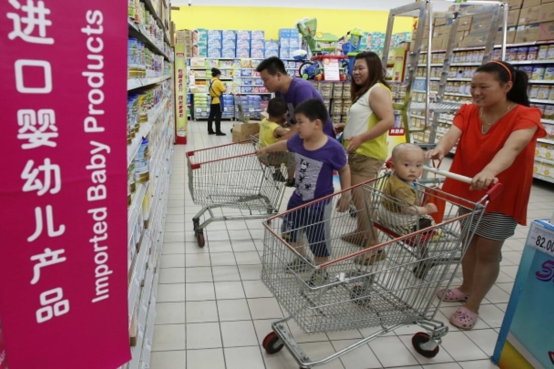 Chinese shoppers look over foreign milk powder brands. Photo: Reuters