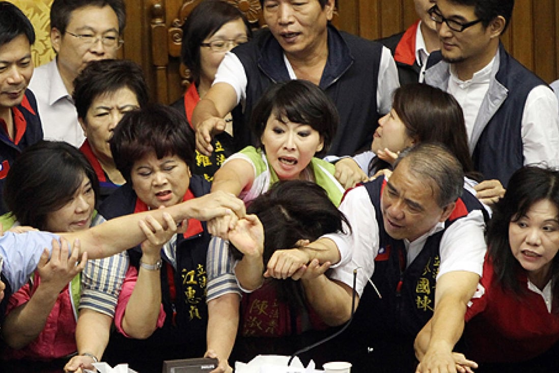 Fighting breaks out in Taiwan's parliament as lawmakers debate a capital gains tax in June. Two-thirds of Taiwanese respondents in a poll said they believed corruption was a problem or serious problem. Photo: AFP