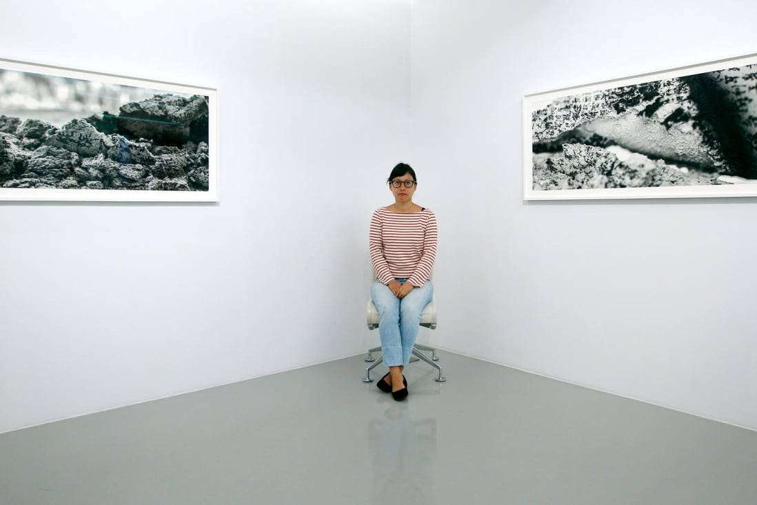Tsai Charwei sits between photographs from the Incense Mantra series. Photos: Jonathan Wong