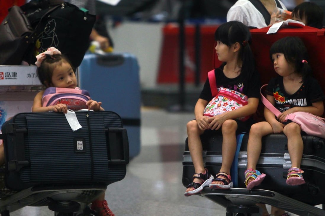 Children stranded at the Beijing Capital International Airport after their flights were cancelled due to heavy rain. Beijing and Shanghai rank at the bottom of 35 major international airports for flight delays and cancellations in a recent survey. Photo: AP