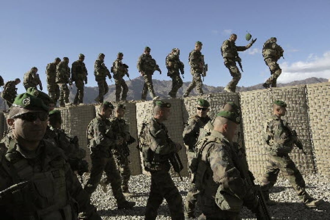 Nato troops on patrol in Afghanistan. In the lastest attack, a suicide bomber rode a donkey into an military convoy, killing three western soldiers and an Afghan interpreter. Photo: AP