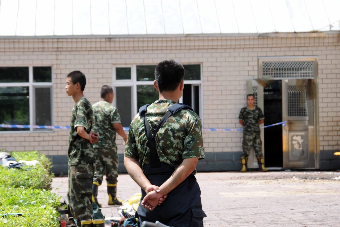 Firefighters are seen at the accident site at the Lianhe Senior Nursing Home where a fire took place. Photo: Xinhua