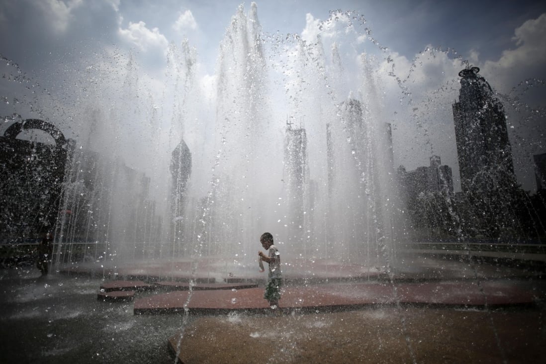 A boy cools off in a fountain at a park in Shanghai. Hot weather has set in with temperatures rising up to 40 degrees Celsius in Shanghai. Photo: AP