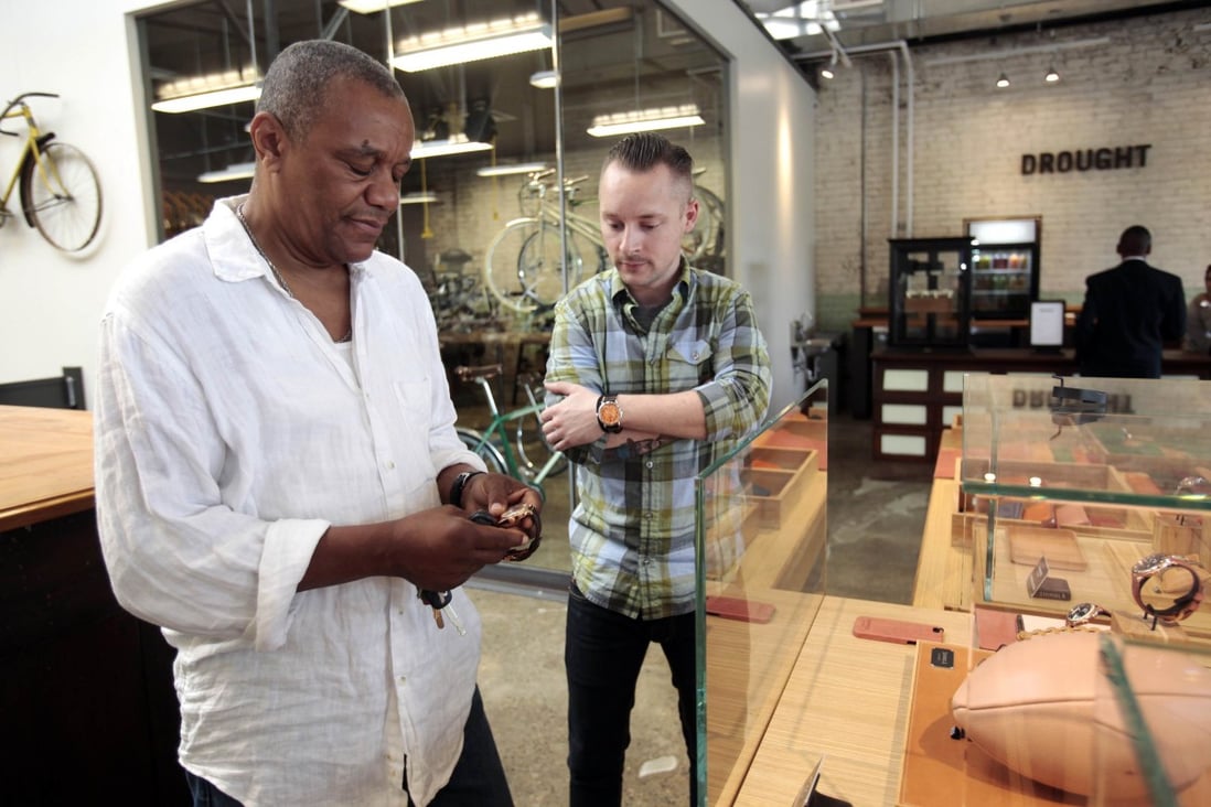 A Shinola employee (right) helps a customer with a Shinola watch. Small companies like Shinola are helping to revive the ‘Made in Detroit’ brand. Photo: Reuters