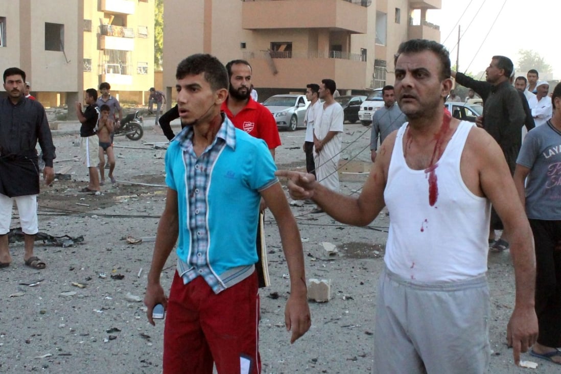 Injured men walk away from an explosion in the northern Syrian city of Raqqa. UN weapons inspectors tasked with looking into claims of chemical weapons use in Syria are now planning to leave. Photo: AFP
