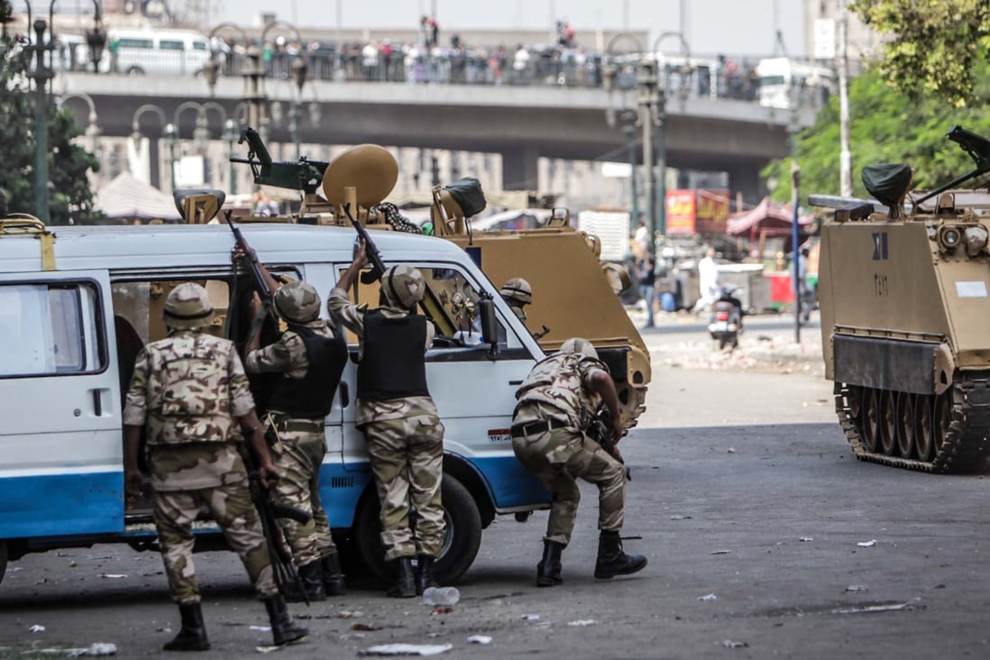 Soldiers firing during clashes in Ramses Square, Cairo. Photo: Xinhua