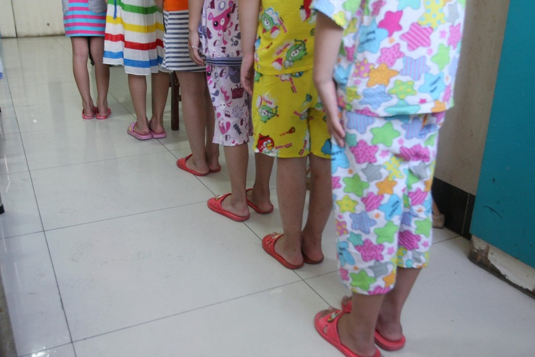 Victims, aged eight and nine, re-enact how they say their teacher made them queue outside his office to be abused. Photo: Mimi Lau