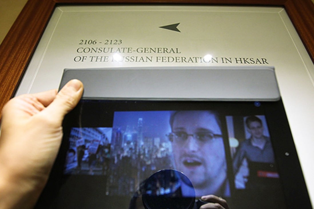 Images of Edward Snowden are seen on an iPad in front of a sign for the Consulate-General of the Russian Federation in HKSAR, Wan Chai. Photo: Jonathan Wong