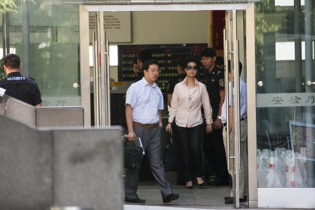 Defendant Li Guanfeng's mother, Meng Ge, leaves court in Beijing's Haidian district yesterday. Photo: CNS